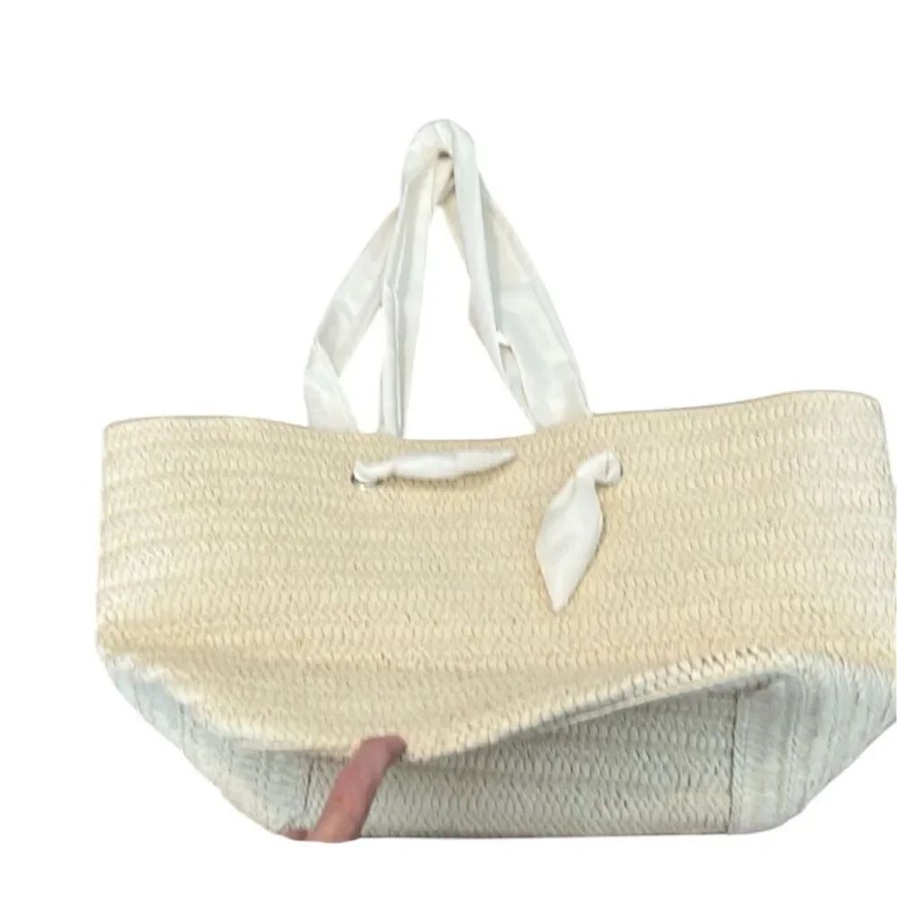 Dezine news inc NWOT straw tote bag with fabric handles 1 small spot on 1 handle
